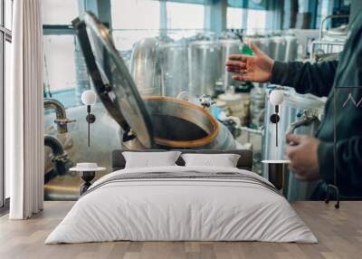 Cropped shot of a large metal tank with craft beer in a brewery Wall mural