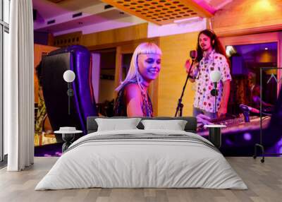 Female sound engineer working at mixing panel in a music recording studio Wall mural