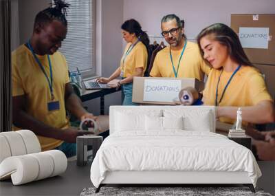 Group of multiracial volunteers working in community charity donation center Wall mural