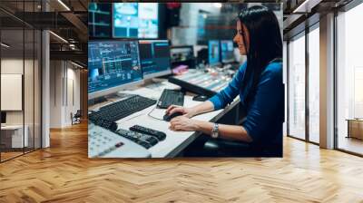 Middle aged woman using equipment in control room on a tv station Wall mural