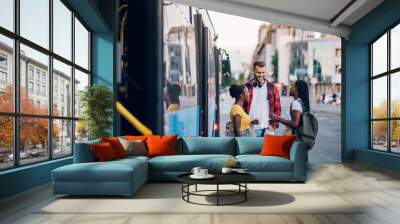 Multiracial group of people waiting for a public transport on a bus station Wall mural