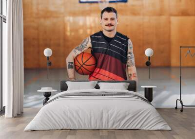 Portrait of confident smiling tattooed hispanic man basketball player Wall mural