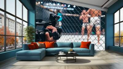 Professional sports cameraman recording boxing match Wall mural