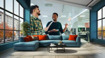 Two male business man writing strategy ideas on sticky notes in the office Wall mural