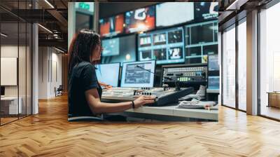 Young beautiful woman working in a broadcast control room on a tv station Wall mural