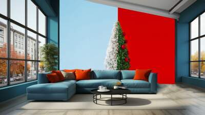 Christmas tree half with snow on duotone background. Minimal winter season New Year creative concept. Wall mural