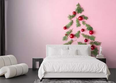 Christmas tree made with evergreen fir, bauble decoration and cinnamon sticks on pastel pink background. Minimal holiday flat lay table compoition with copy space. Wall mural