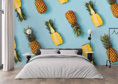 Colorful pattern of pineapples on pastel blue background. Top view. Minimal tropical fruit summer concept. Wall mural