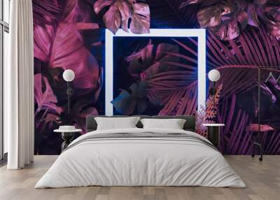 Creative fluorescent color layout made of tropical leaves with neon light square. Flat lay. Nature concept. Wall mural