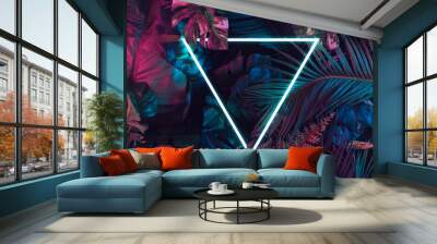 Creative fluorescent color layout made of tropical leaves. Flat lay neon colors. Nature concept. Wall mural