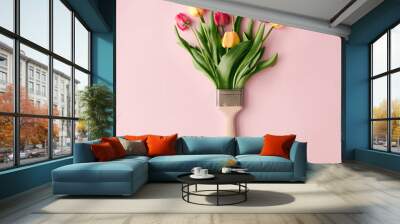 Creative spring concept made with paint brush and colorful tulip flowers on pastel pink background. Minimal nature flat lay. Wall mural