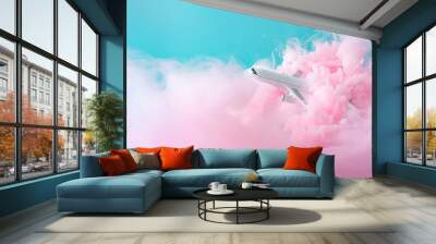 Passenger jet airplane flying through pastel pink clouds. Minimal transportation, travel or vacation concept. Wall mural