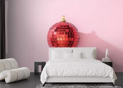 Red Christmas disco ball bauble on pink background. Minimal New year  party concept. Flat lay. Wall mural