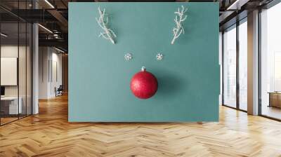 Santas reindeer made with Christmas bauble decoration and white snowy winter branches. Minimal flat lay Christmas concept. Wall mural