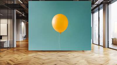 Yellow balloonon blue sky. Minimal concept. Wall mural