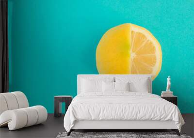 Yellow lemon fruit on bright blue background. Minimal flat lay concept. Wall mural