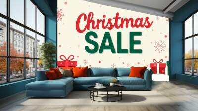 Bright and cheerful Christmas sale banner features large festive typography in red and green, surrounded by gift boxes and holiday decorations, perfect for attracting shoppers Wall mural