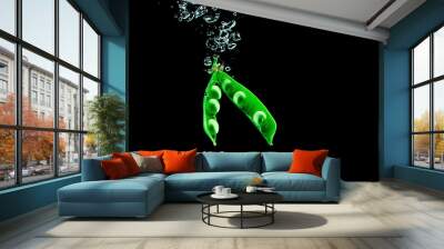 Fresh pea dropped into a water on dark background isolate. Wall mural