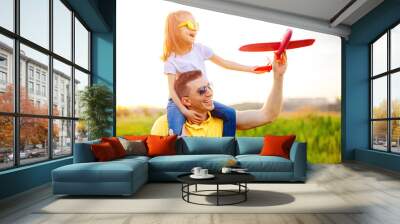 Happy father and daughter playing with plane Wall mural