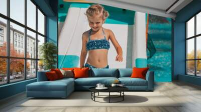 happy little girl splashing around in the pool. Wall mural