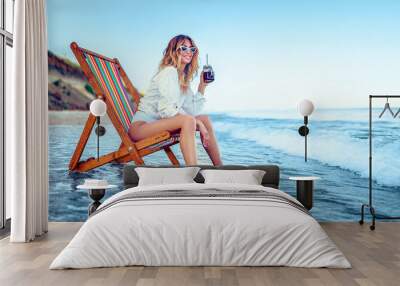 Pretty woman relaxing on a lounger beach and drinks soda water. summer vacation concept. Wall mural