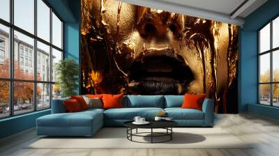 Stunning portrait showcases a captivating face in radiant gold tones against a bold black background, emphasizing beauty and elegance for a remarkable experience Wall mural