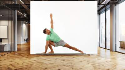 Young handsome man doing yoga isolated on white background Wall mural