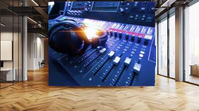 Professional audio studio sound mixer console board panel with recording , faders and adjusting knobs,TV equipment. Blue tone and close-up image with flare light effect. Wall mural