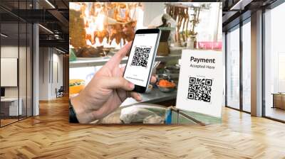 Qr code payment , online shopping , cashless technology concept. Restaurant in market accepted digital pay without money , plastic tag on table and hand using mobile phone application to scan qr code. Wall mural