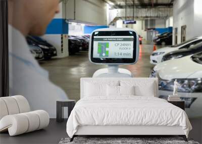 Robotics Trends artificial intelligence technology , indoor cars parking concept. Autonomous personal assistant robot navigation direction customer to his car and application ui. Wall mural