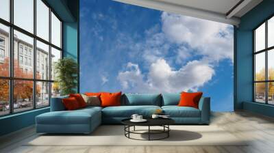 Cumulus clouds on blue sunny spring sky, nature background. Wall mural