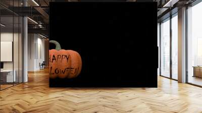 Halloween pumpkin with text Happy Halloween on black background space for text Wall mural