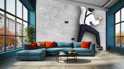 Businessman climbs the wall as a climber, business concept Wall mural