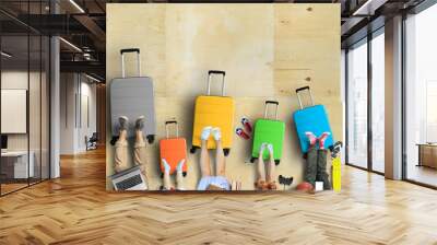 Family is going on a trip, five colored suitcases with clothes and accessories for recreation. Wall mural