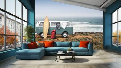 Tourist camp with bags, surfboard and car on the ocean Wall mural