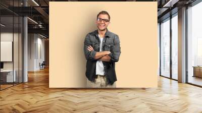 Young man in denim shirt is smiling Wall mural