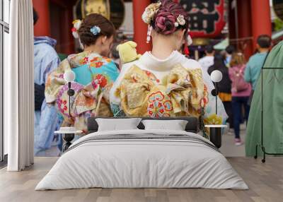 Young girl wearing Japanese kimono standing in front of Sensoji Temple in Tokyo, Japan. Kimono is a Japanese traditional garment. The word 