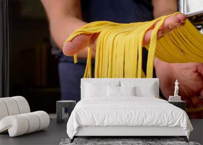 noodles and pasta machine and male hand Wall mural