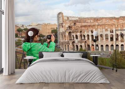 Female photographer holding photocamera and taking photo of Colo Wall mural