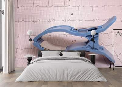 limb ecg electrode with ecg record on paper in background Wall mural