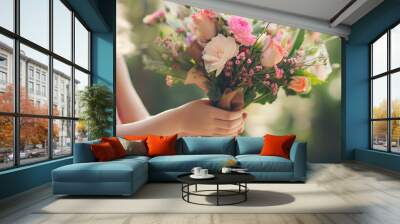 Flowers bouquet in the hand of a little girl Wall mural