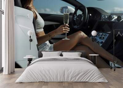 A wealthy woman with a glass of champagne in luxury car Wall mural