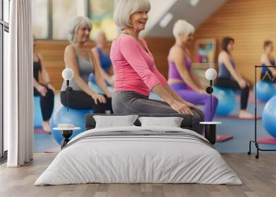 Caucasian senior people doing exercise with balance ball at gym Wall mural