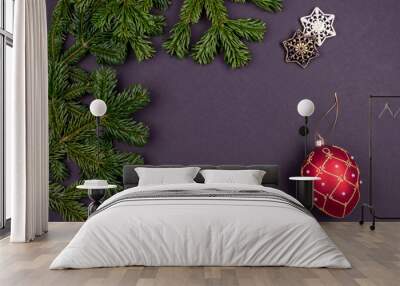 Festive composition with colorful Christmas decoration and fir branches on dark grey background Wall mural