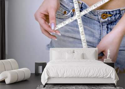 girl measuring her waist Wall mural