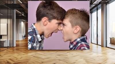 Two angry brothers standing face to face, quarreling, shouting and looking at each other Wall mural