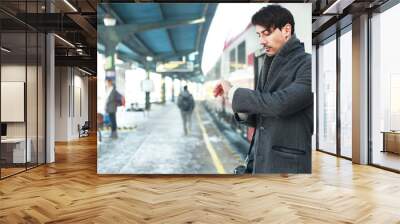 man looking at his watches Wall mural