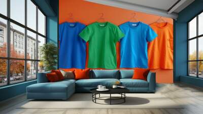 T shirt with many colors hanging on the rail Wall mural