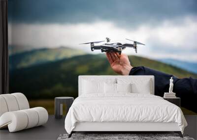 The drone with the professional camera takes pictures in the mountains Wall mural