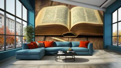 A book is open on a wooden table with a pen on the table Wall mural